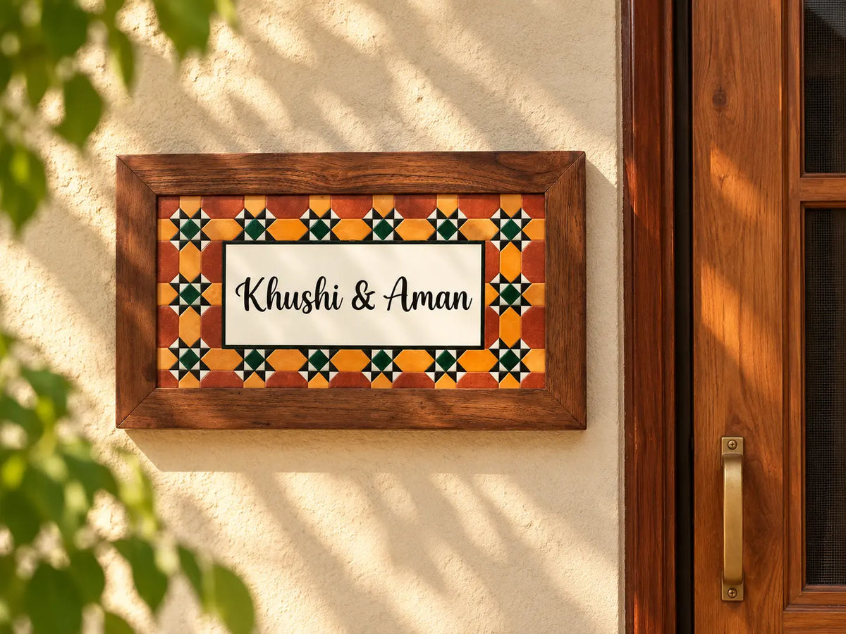 Mosaic tile border name plate in terracotta, mustard and green with script lettering in a wooden frame